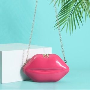 Pink small Lip-shaped Crossbody. Height: 5.5 in 
Length: 9.1 in 
Width: 2.8 in